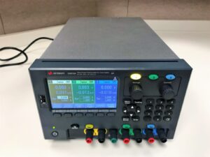 Precision Keysight E36312A DC power supply with triple output, ideal for testing and calibration.