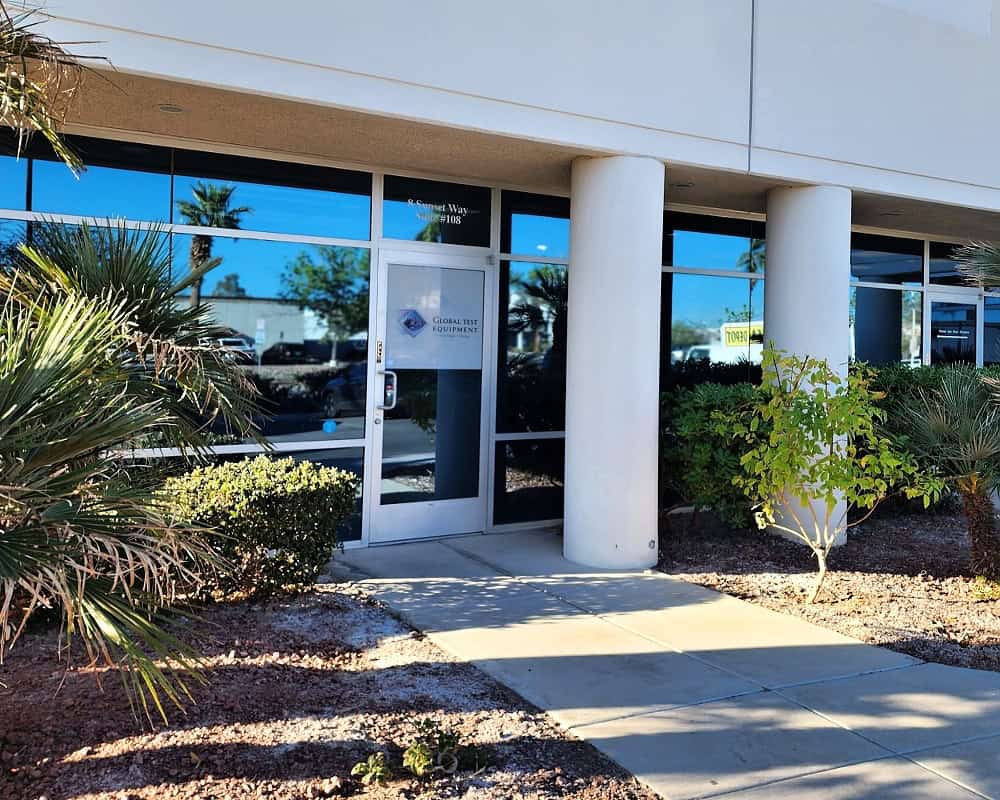 Entrance to Global Test Equipment office with glass doors and landscaping.