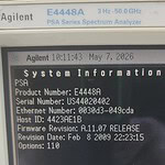 Close-up of Agilent E4448A spectrum analyzer screen showing system info and firmware details.