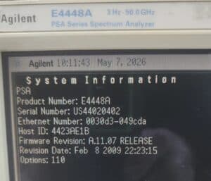 Close-up of Agilent E4448A spectrum analyzer screen showing system info and firmware details.