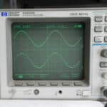 Hewlett Packard 54602B oscilloscope displaying a sine wave at 150 MHz.